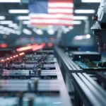 A high-tech electronics manufacturing facility in the USA, featuring robotic arms and assembly lines under the American flag.