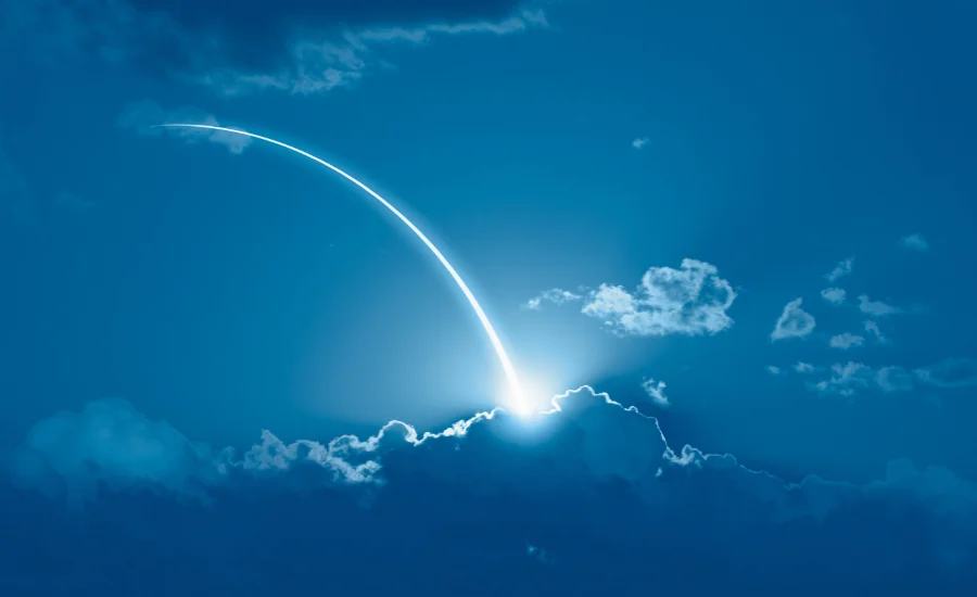 Military rockets launch with fire clouds at night