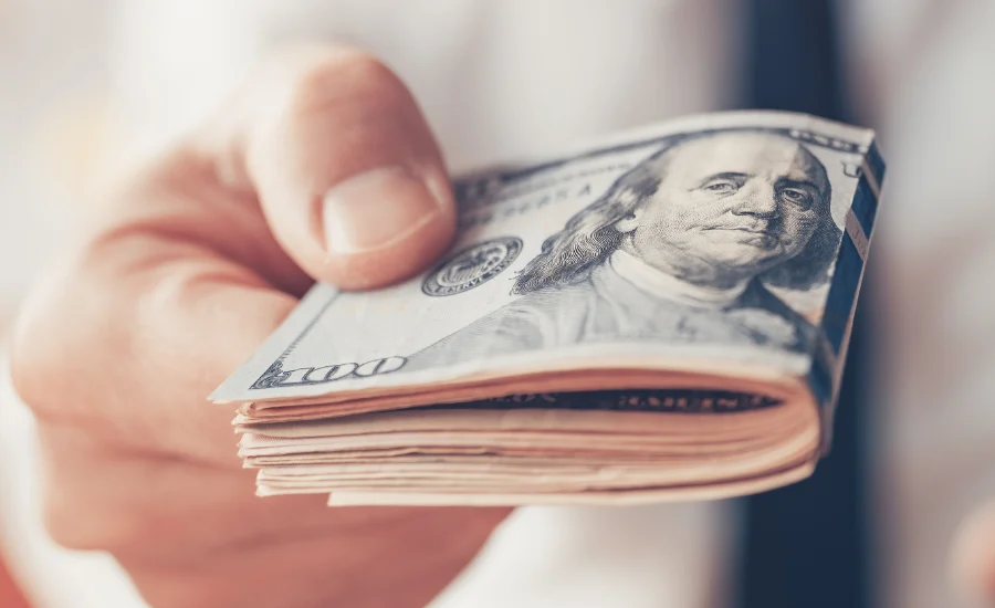 Financial loan, businessman offering US dollar paper currency ca