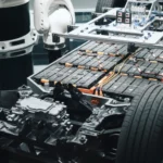 industrial robot installing electric vehicle battery modules automation replacing ev battery pack in modern car factory in production line