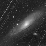 the-andromeda-galaxy-a-celestial-spectacle-revealed-through-the-lens-of-earthly-imperfections