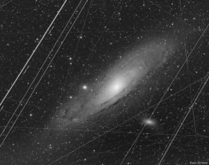 the-andromeda-galaxy-a-celestial-spectacle-revealed-through-the-lens-of-earthly-imperfections