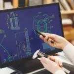 Engineer working on cad scheme using computer tools.