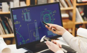 Engineer working on cad scheme using computer tools.